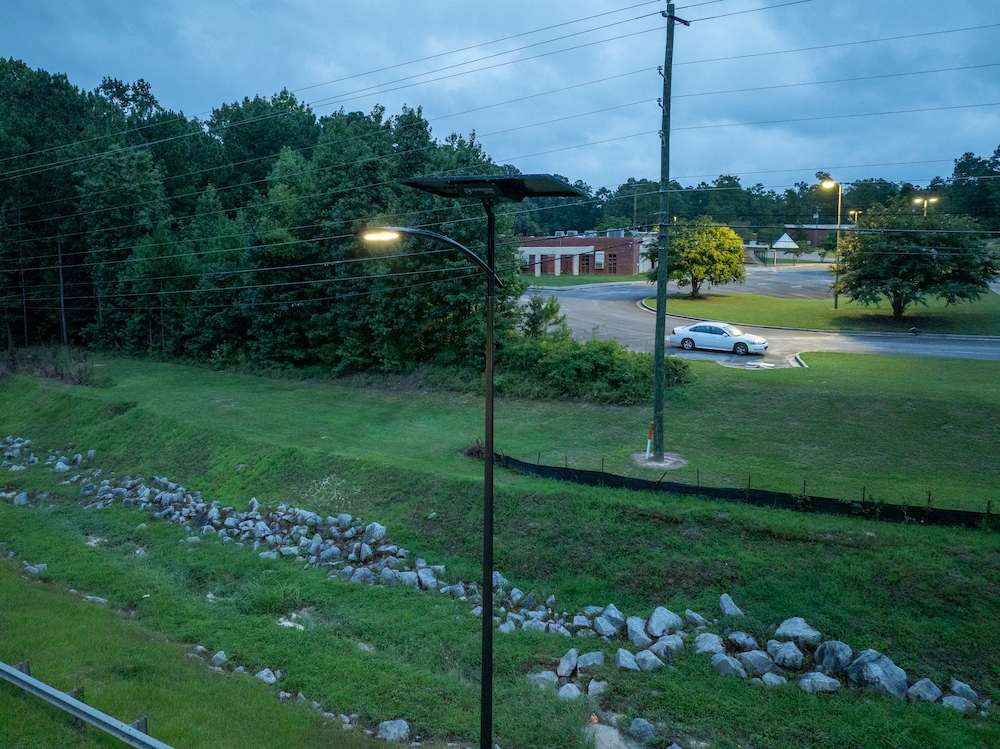 Solar-powered streetlight illuminating a roadside area in Alabama, enhancing safety and visibility with off-grid lighting technology
