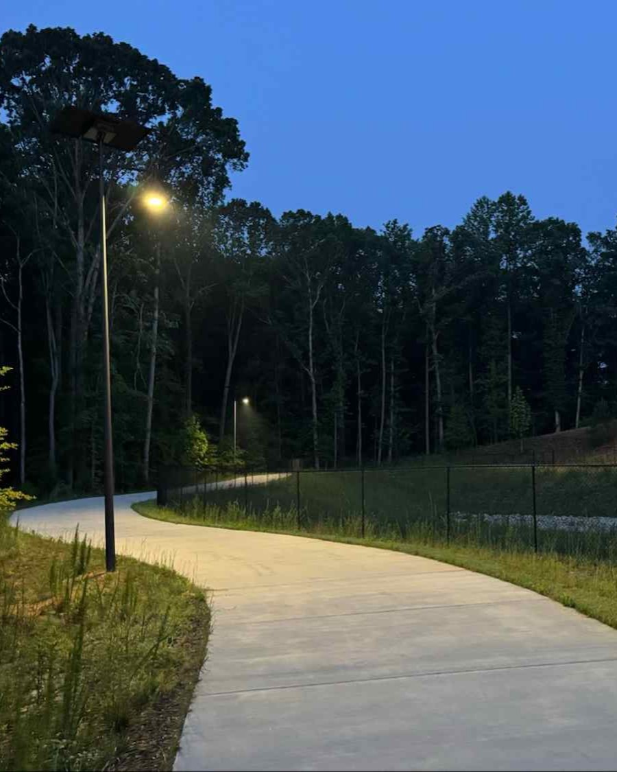 Solar-powered streetlights illuminating a walking trail in Alabama, providing safe, off-grid lighting for parks and greenways