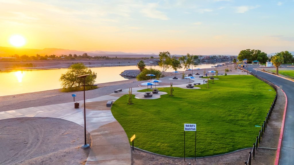 Bob Belt’s Beach Park in Needles, California, at sunset with solar-powered lights along the riverwalk and picnic areas.