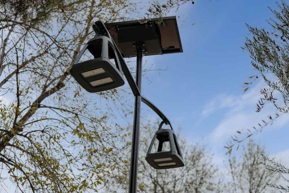 Close-up of a dual-head solar street light fixture in California against a blue sky