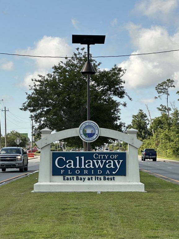 New Florida residential subdivision entrance lit with modern solar streetlights