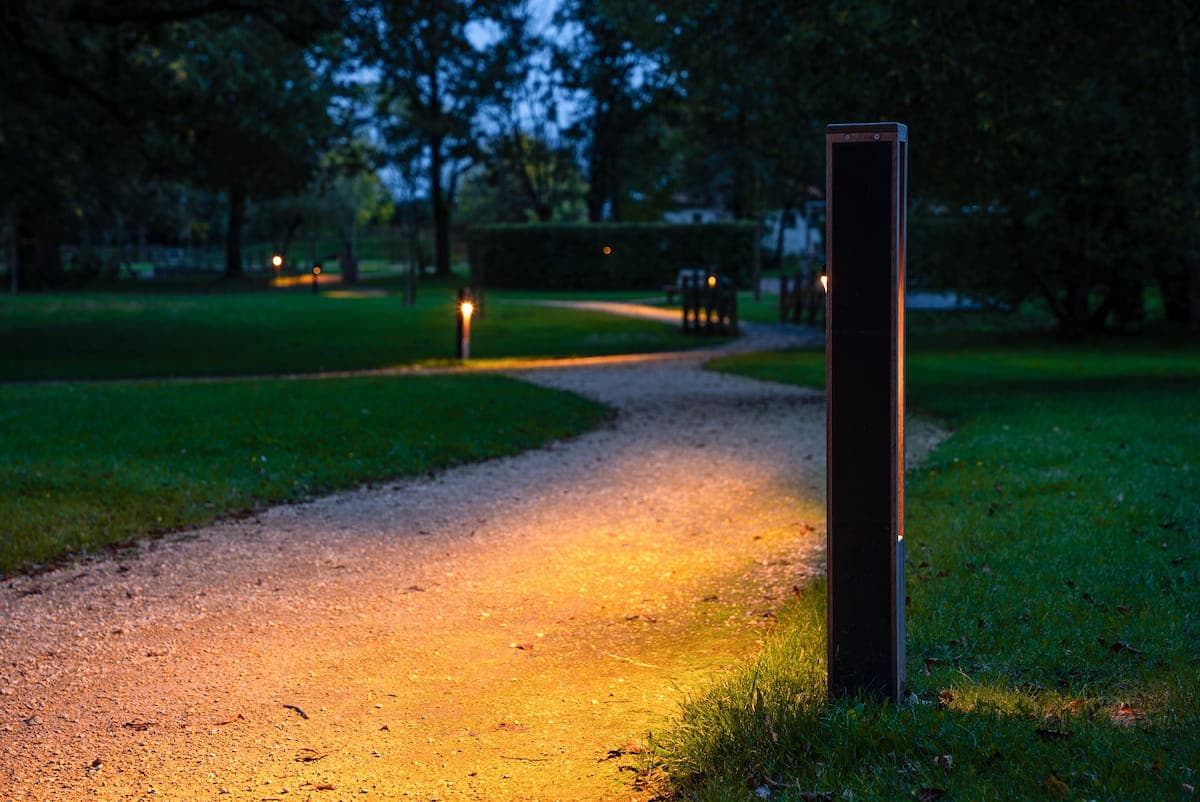A row of solar-powered bollard lights lining a pedestrian path, enhancing visibility and aesthetics.