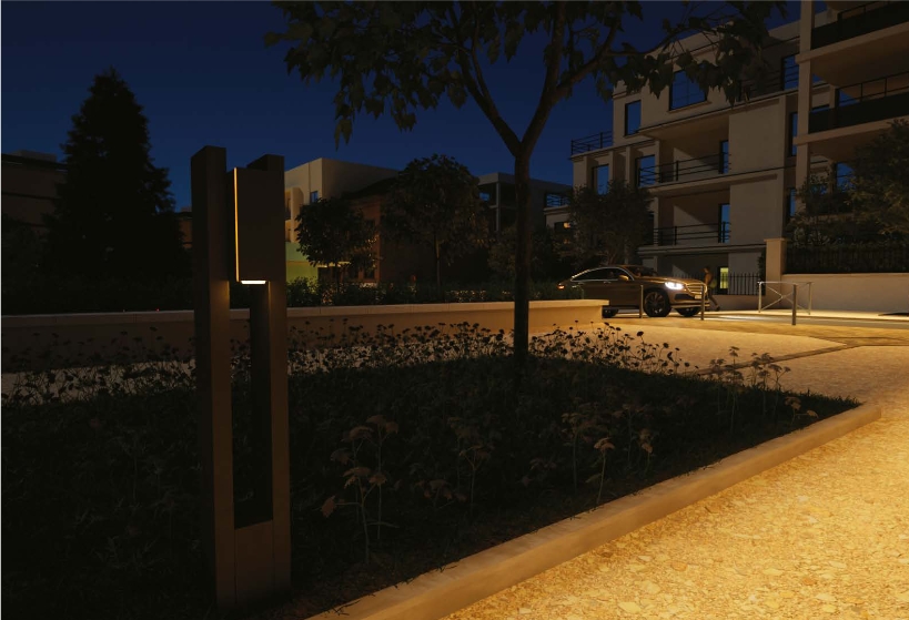 Nowatt solar bollard lighting a landscaped pathway in a residential complex at night.