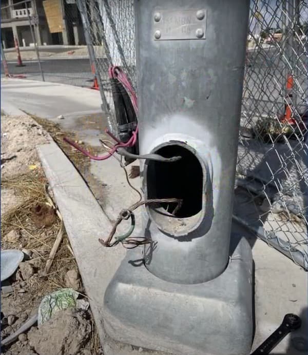 Open roadside electrical junction box with exposed and severed wires, illustrating infrastructure damage from copper theft in Georgia.