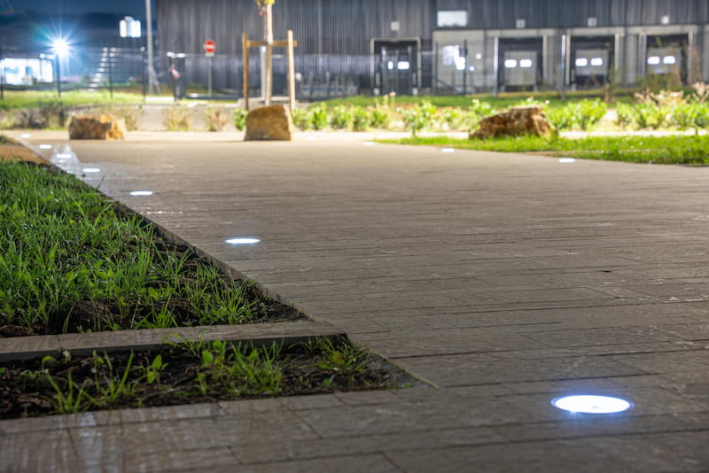 Solar-powered lights illuminating a bike trail, providing safe and sustainable lighting for cyclists and pedestrians during nighttime.