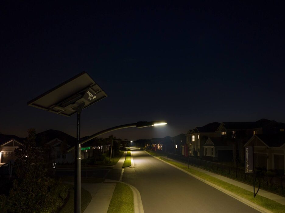 Overhead view of a lit Florida trail network weaving through wetlands and conservation areas, powered entirely by off-grid solar lighting.