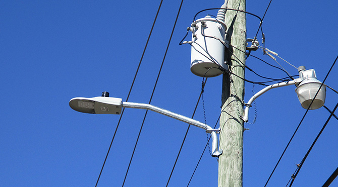 grid tied street light on a wooden pole