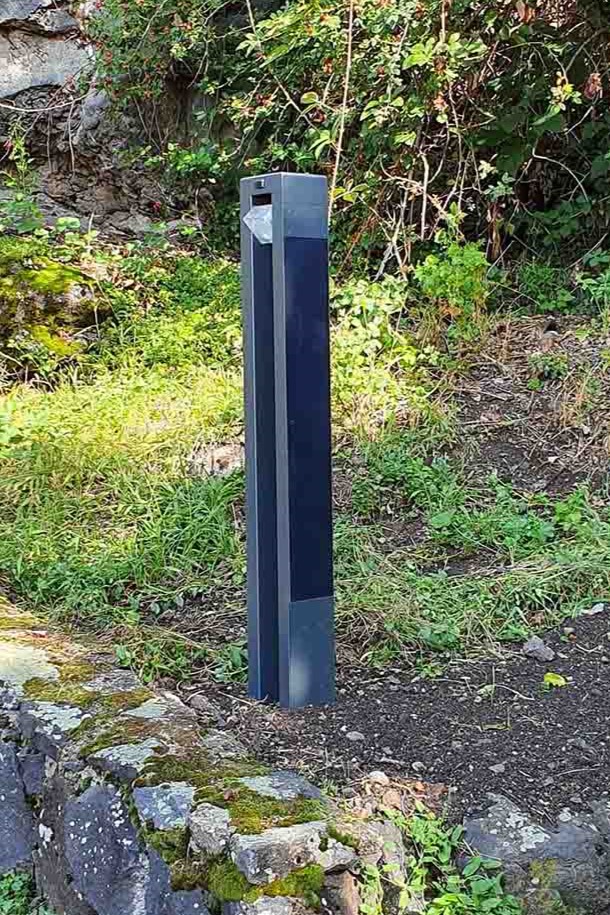 Stylish NOWATT Onyx solar bollard offering aesthetic and functional lighting for pathways in public spaces.