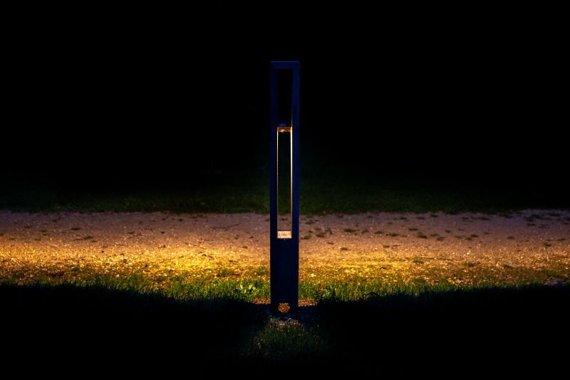 Oko solar bollard lighting a park pathway at night with sleek, wire-free design
