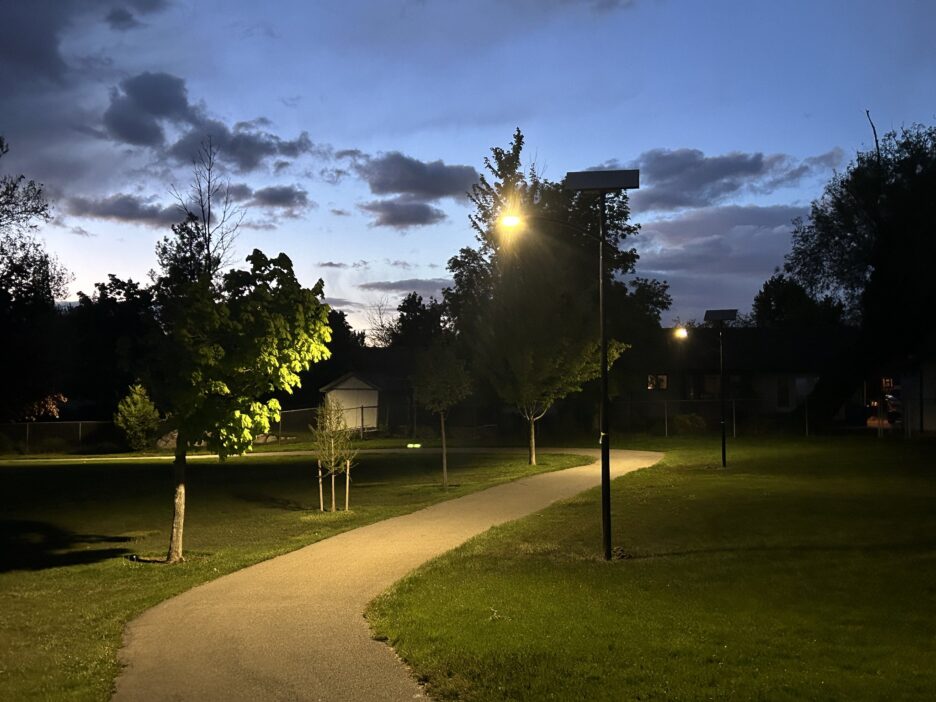 Off-grid solar streetlights illuminating a park pathway in South Carolina at dusk, enhancing safety and accessibility for community recreation areas.