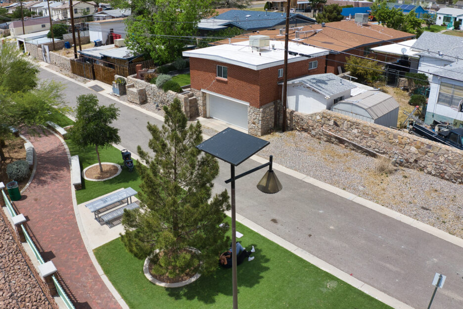 Well-lit urban park with solar street lights improving public security and reducing crime.