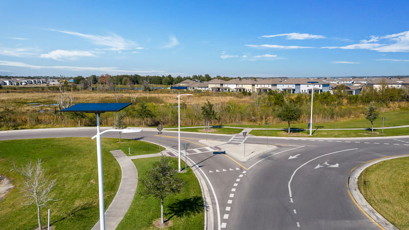 Fonroche solar streetlights illuminating a roundabout near a residential community with sustainable, off-grid lighting