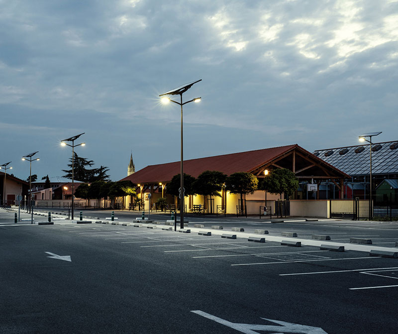 Solar lighting illuminating a parking lot at a commercial property, showcasing energy efficiency, sustainability, and solar lighting solutions. 
