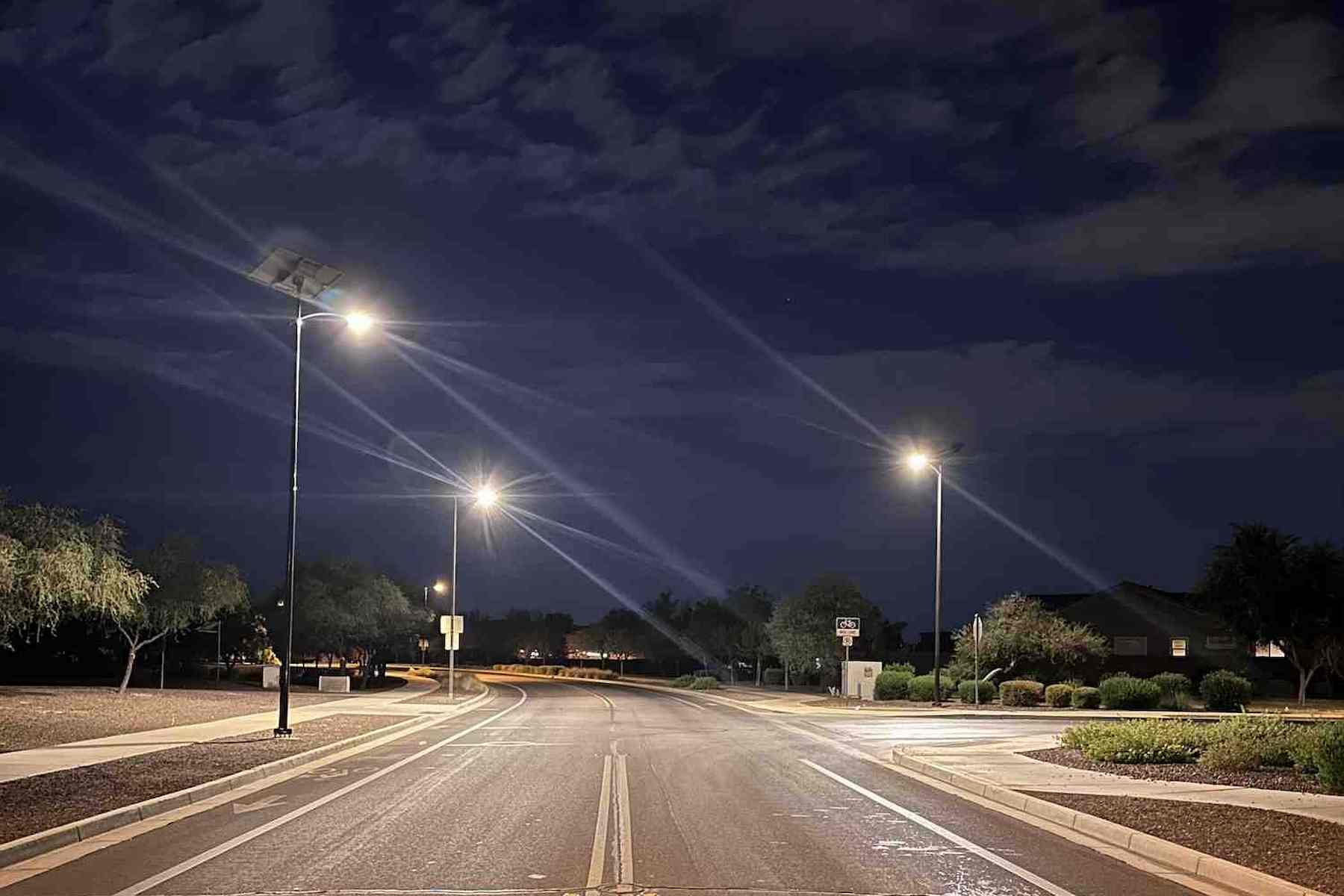 Solar-powered streetlights illuminating a quiet residential road in South Carolina at night, enhancing safety and visibility in a suburban neighborhood setting.
